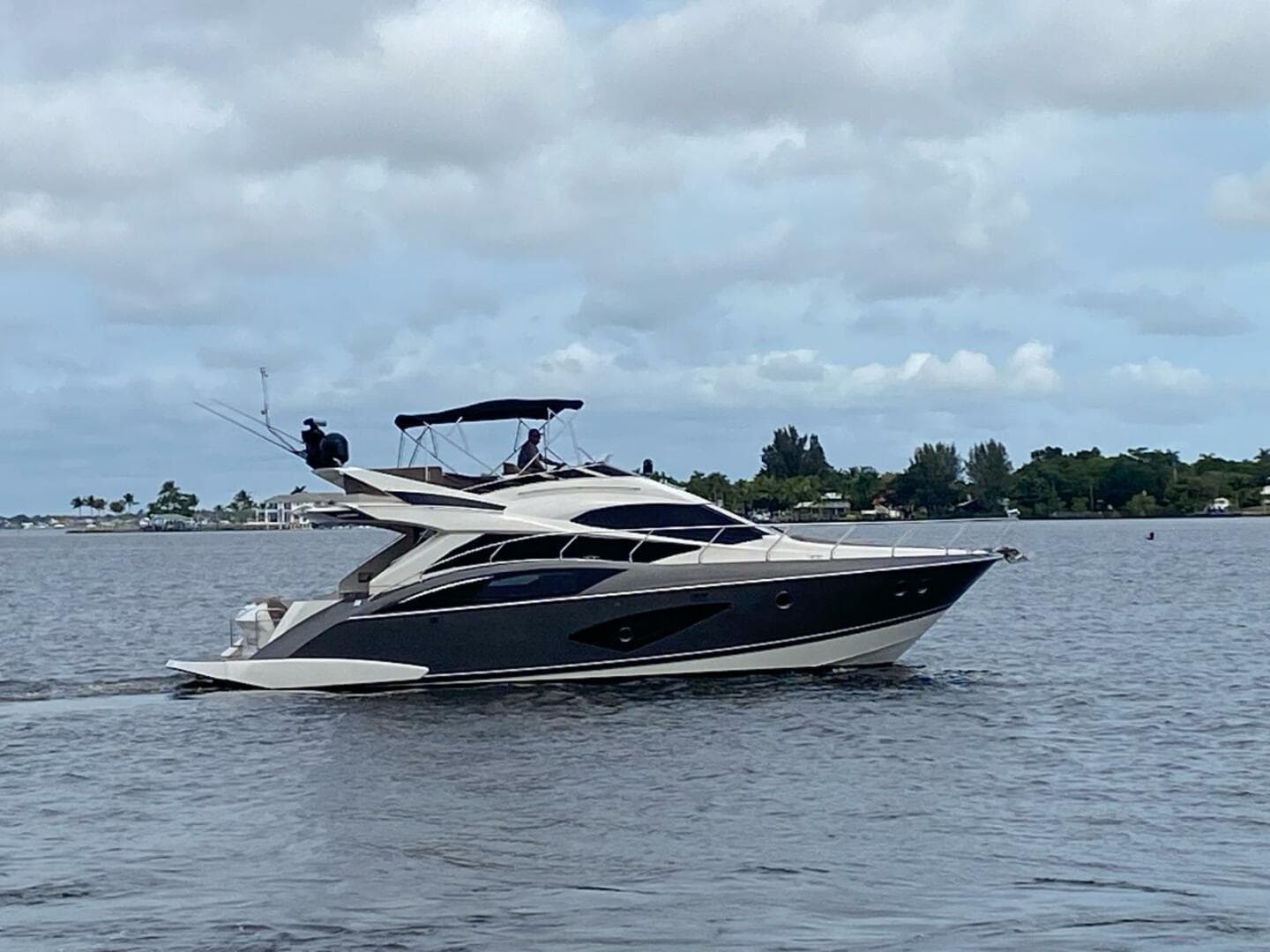 2017 Marquis 500 Sport Yacht cruising on a calm lake.