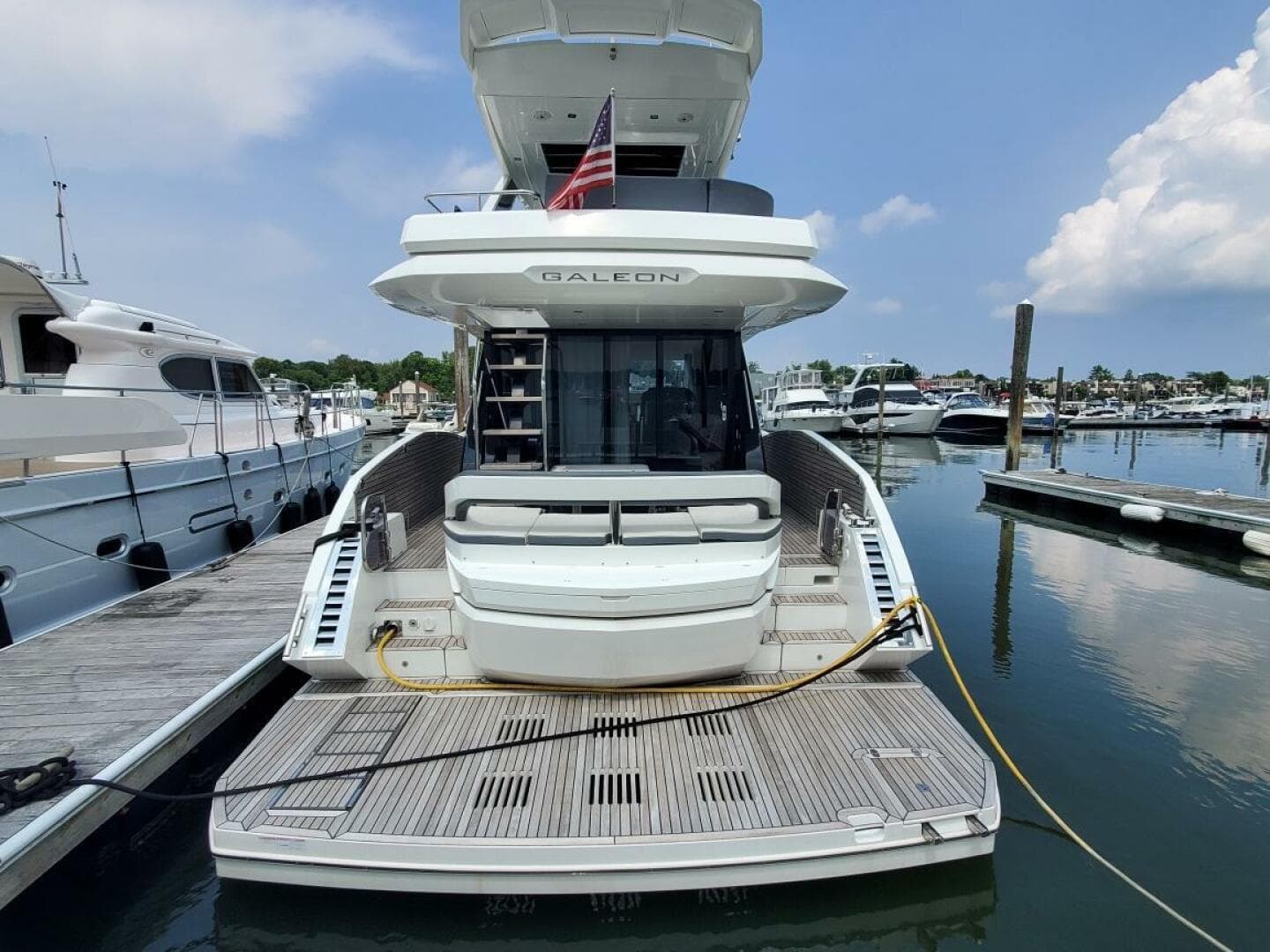 2020 Galeon 500 Fly yacht docked at marina, rear view.