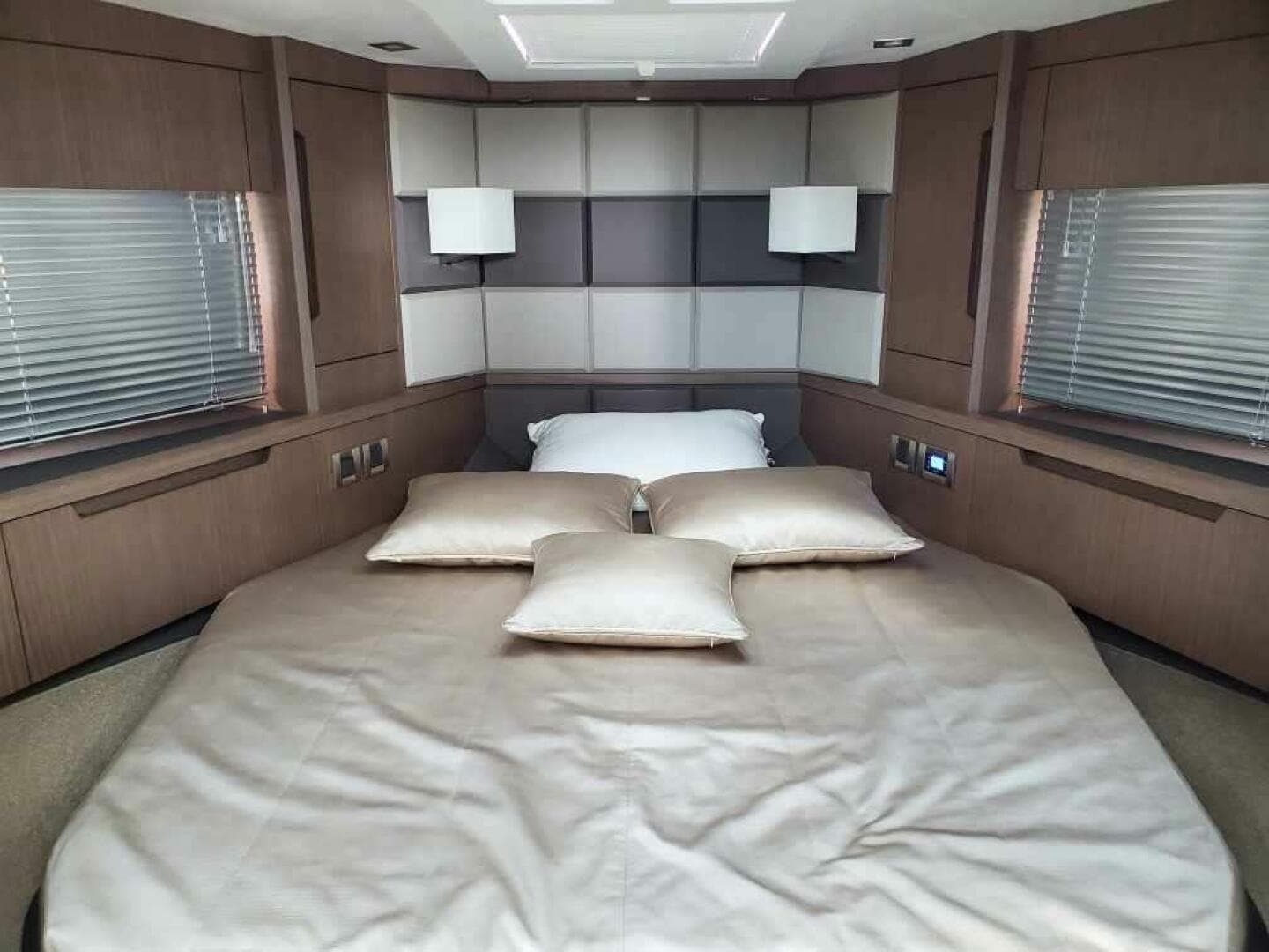 Luxurious bedroom in 2020 Galeon 500 Fly yacht with modern decor and ample natural light.