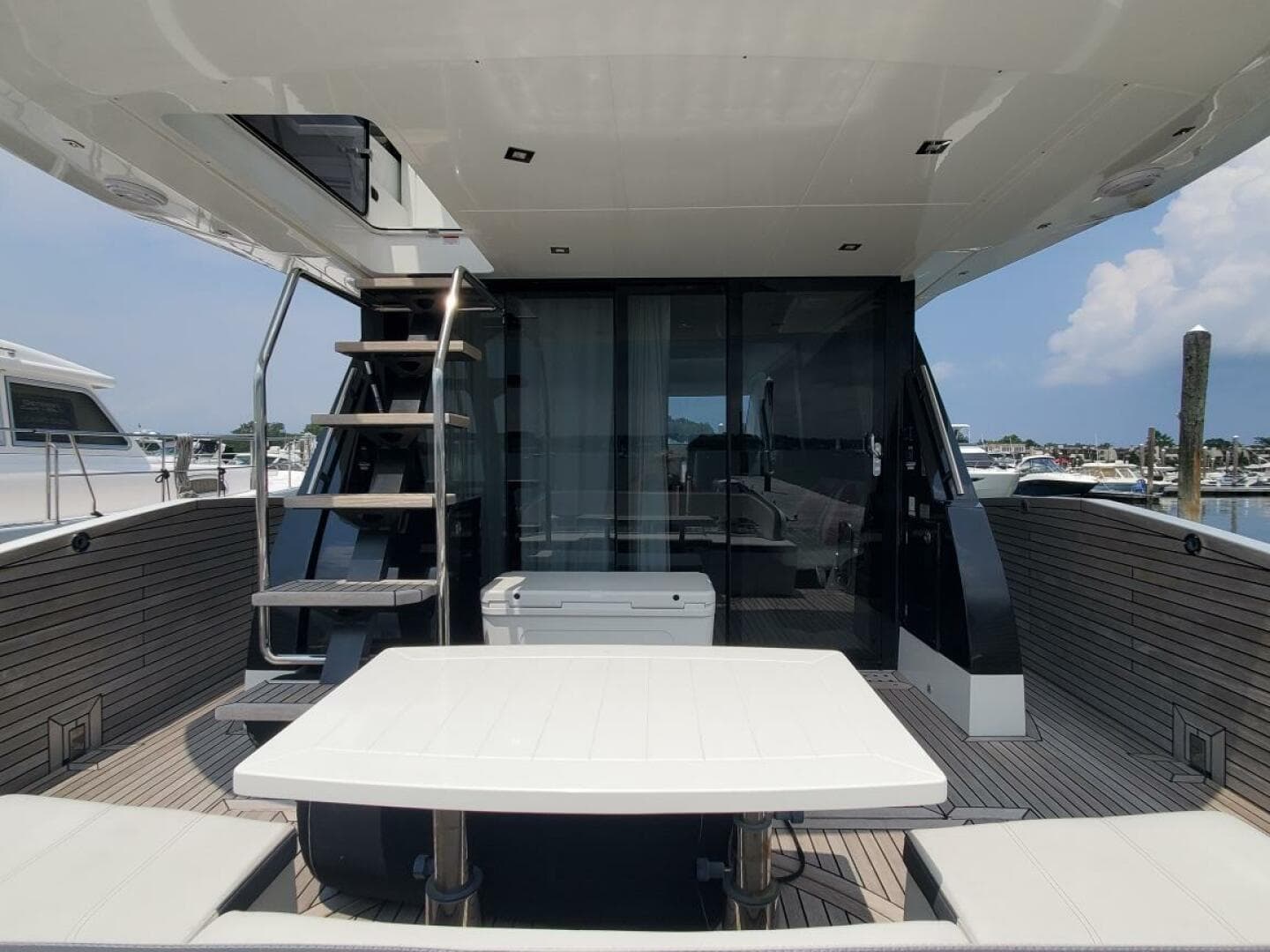 Galeon 500 Fly 2020 yacht with outdoor seating and staircase to upper deck.