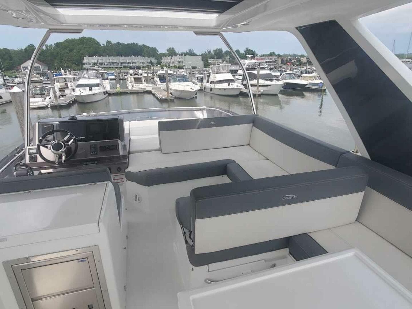 Flybridge of 2020 Galeon 500 Fly yacht with marina view.
