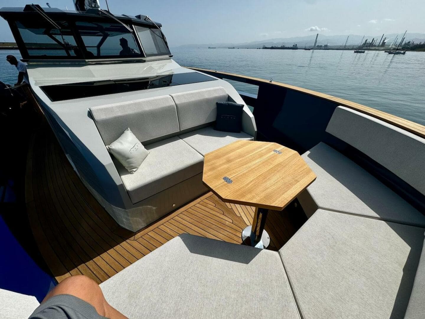 2025 Aicon Audace 50 yacht with elegant deck seating and wooden table.