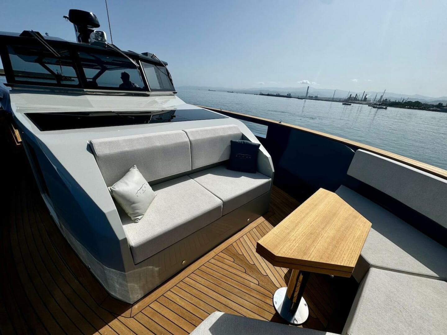 Luxurious 2025 Aicon Audace 50 yacht deck with modern seating and wooden table.