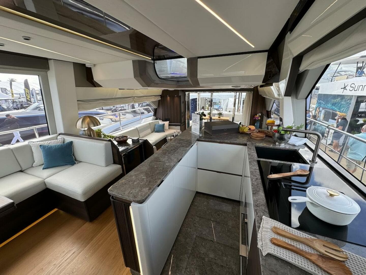 Luxurious interior of 2024 Aicon 66 Vivere yacht with modern kitchen and seating area.