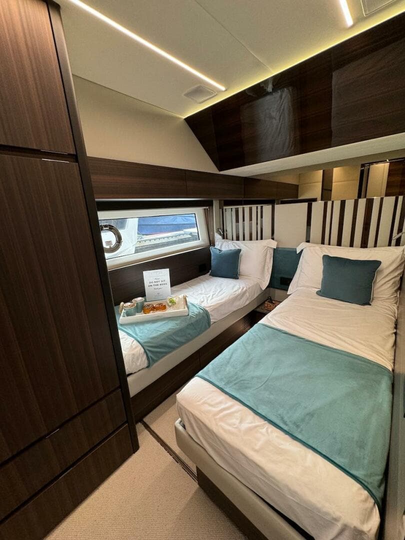 Luxurious 2024 Aicon 66 Vivere yacht cabin with twin beds and elegant decor.