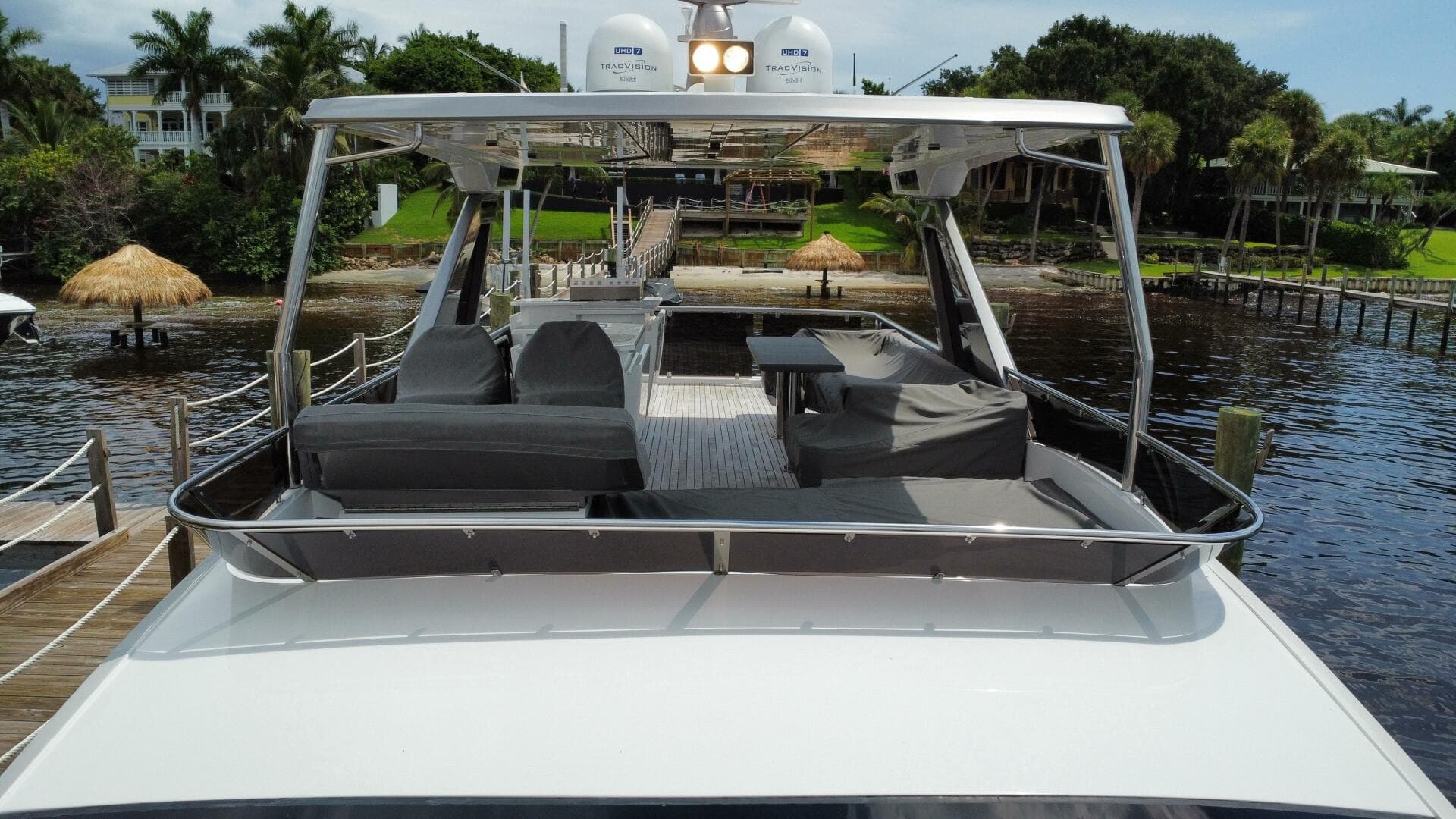 Luxury 2024 Aicon 66 Vivere yacht docked, featuring spacious outdoor seating area.