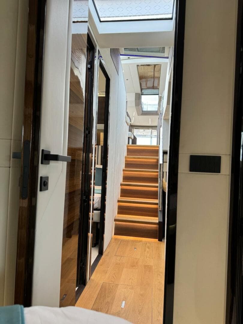 Interior view of 2024 Aicon 66 Vivere yacht with modern staircase and skylight.