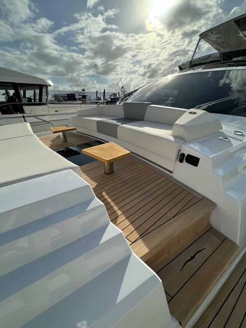 Luxurious 2024 Aicon 66 Vivere yacht deck with elegant seating and wooden flooring.