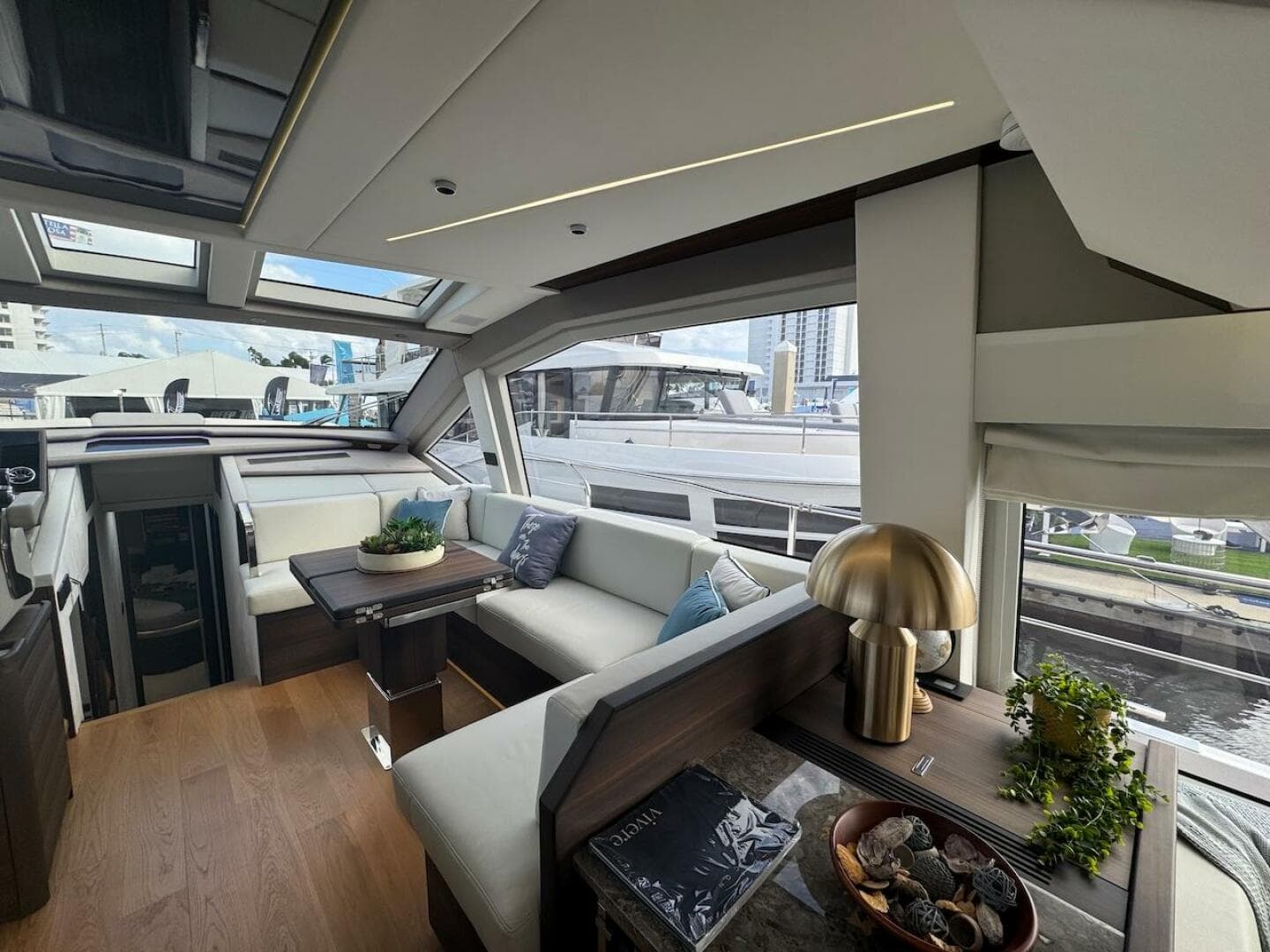 Luxurious interior of 2024 Aicon 66 Vivere yacht with modern decor and panoramic windows.