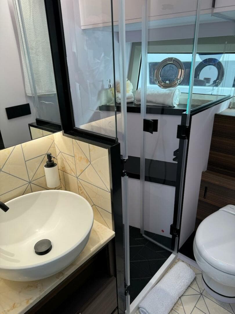Luxurious bathroom in 2024 Aicon 66 Vivere yacht with modern fixtures and elegant design.
