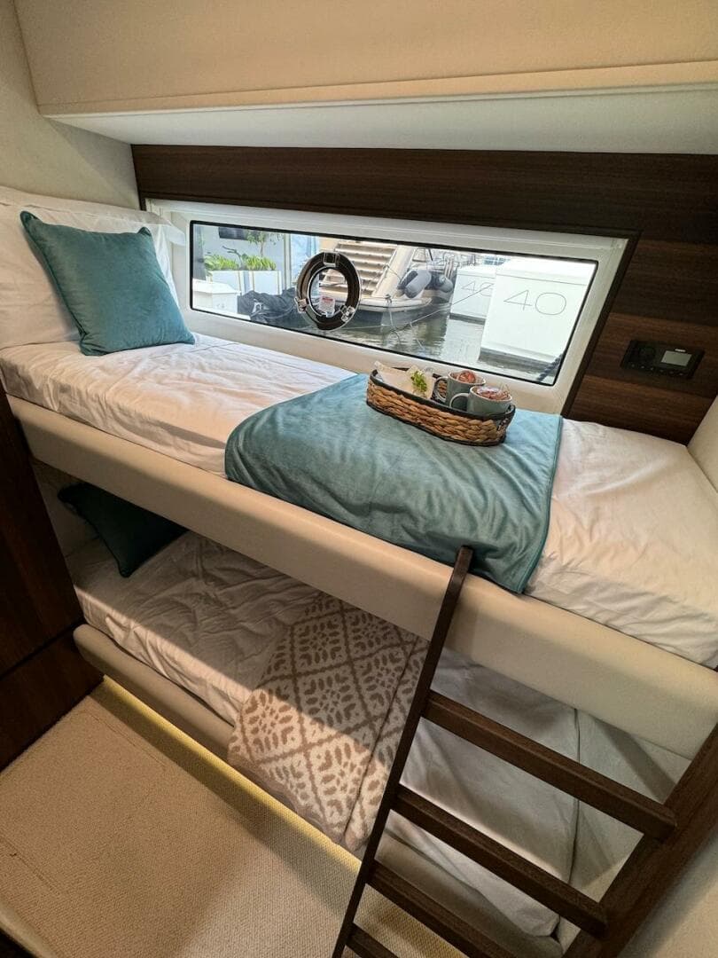 2024 Aicon 66 Vivere yacht interior with cozy bunk beds and elegant decor.