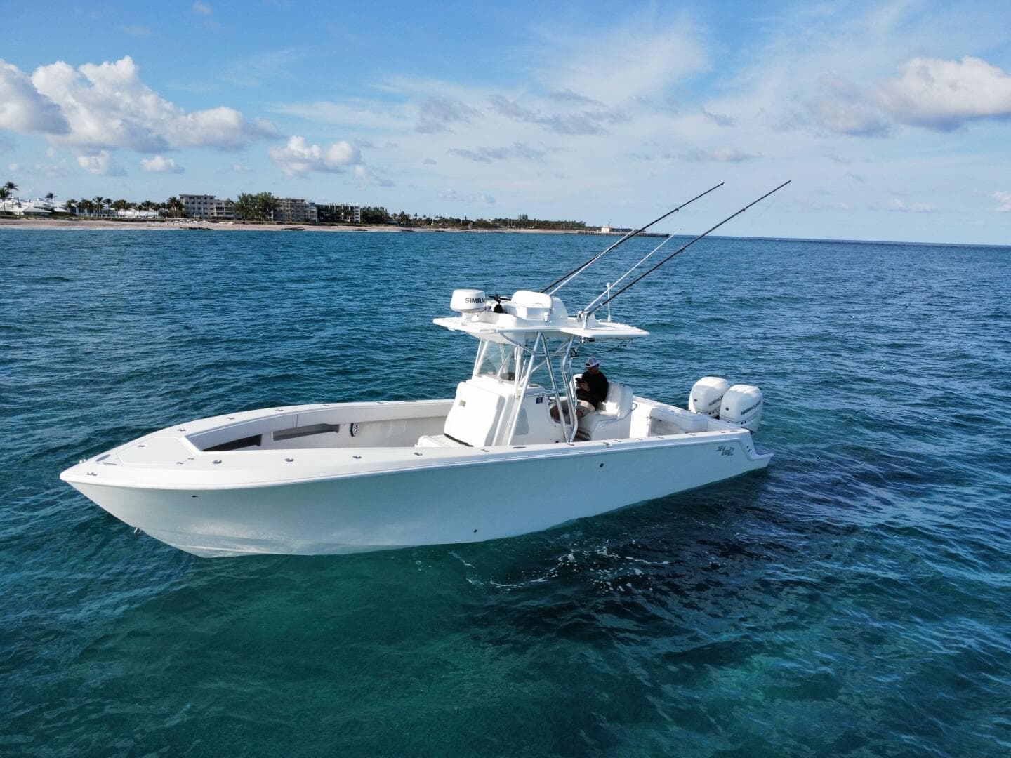 2017 SeaVee 340Z boat on open water, clear sky, fishing rods visible.
