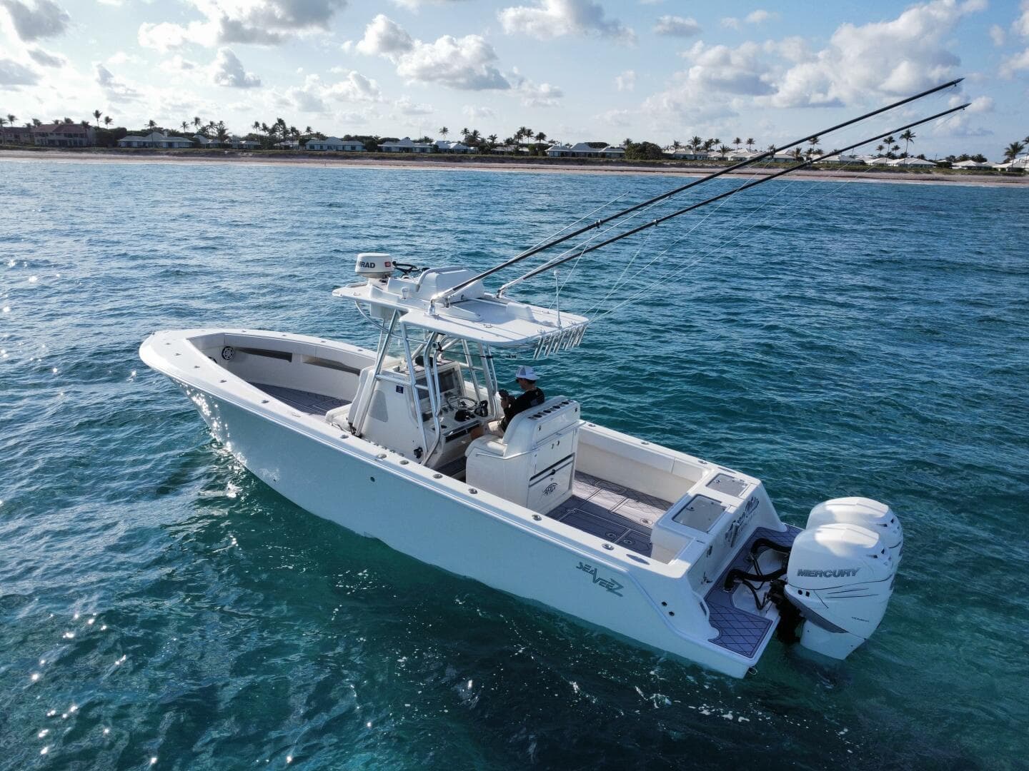 2017 SeaVee 340Z boat on clear ocean water, equipped with fishing rods and Mercury engines.