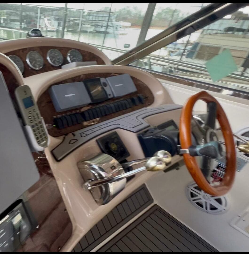 2003 Sea Ray 380 Sundancer helm with wood accents and modern controls.