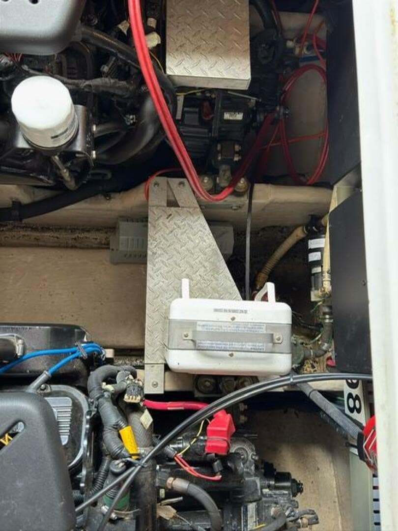 Engine compartment of a 2003 Sea Ray 380 Sundancer with visible wiring and components.