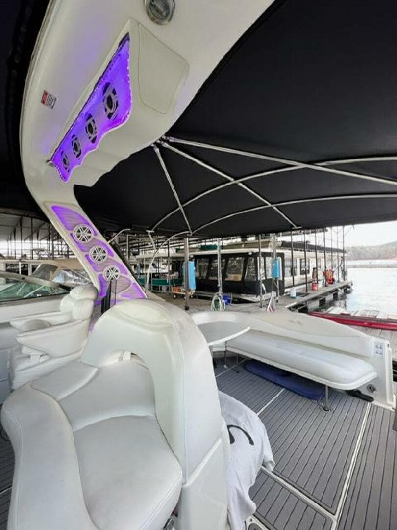 2003 Sea Ray 380 Sundancer boat interior with white seating and purple LED lights.