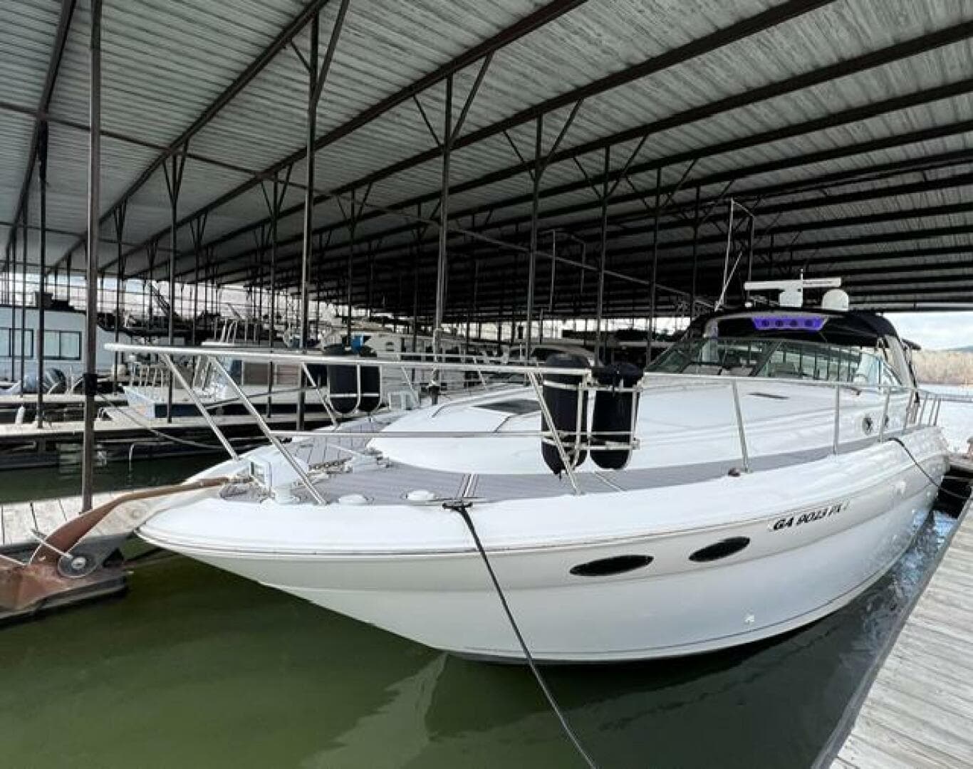 2003 Sea Ray 380 Sundancer docked in a covered marina.