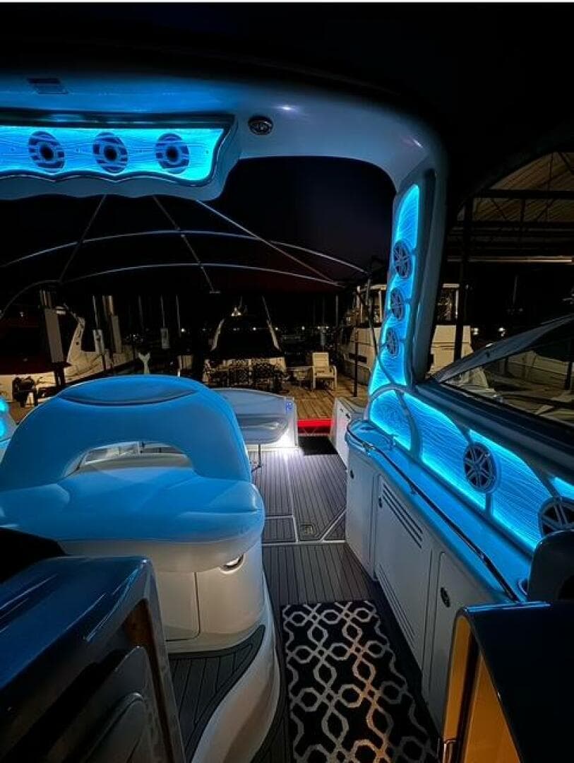 2003 Sea Ray 380 Sundancer yacht interior with blue LED lighting at night.