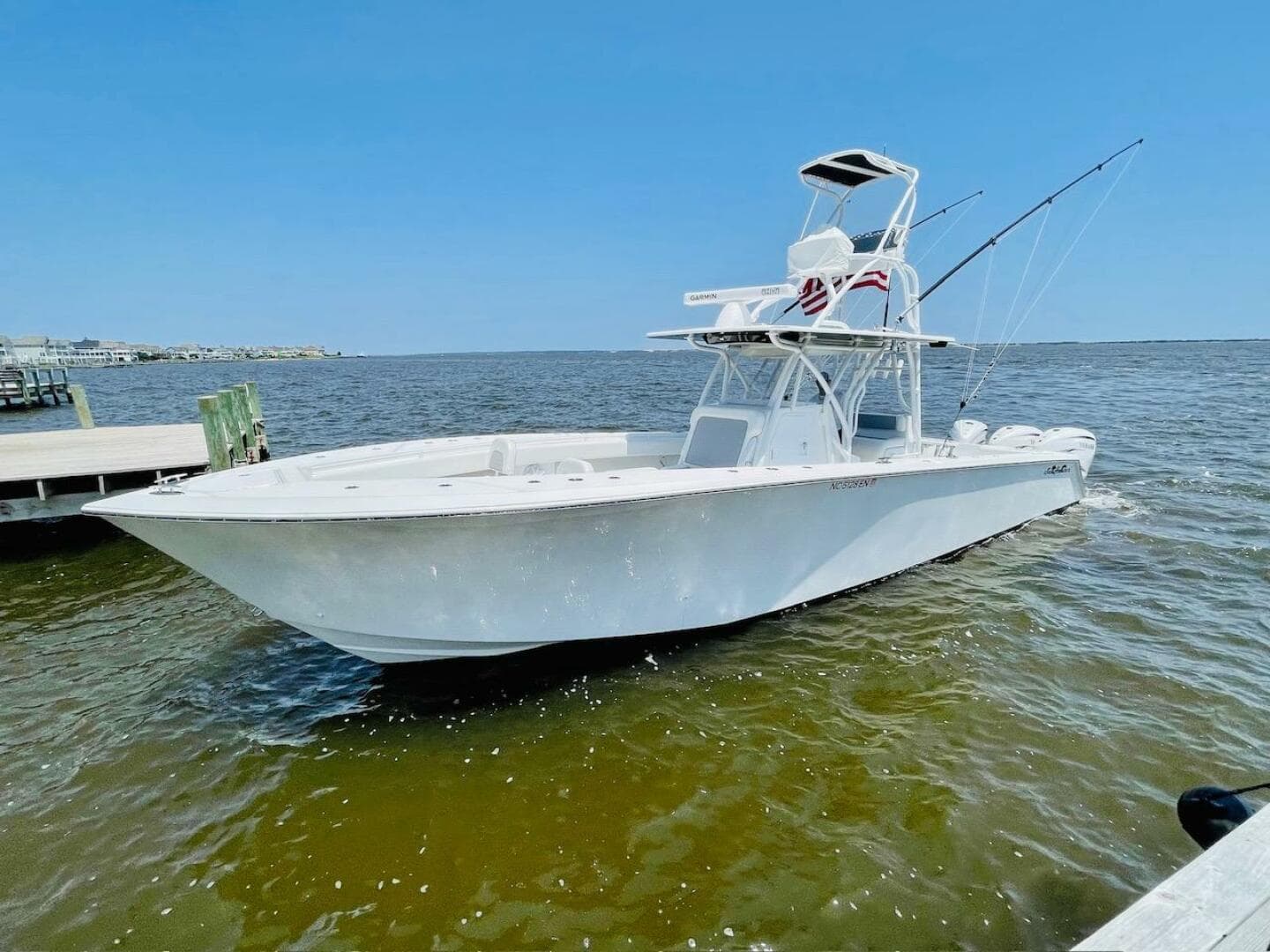 2020 SeaHunter 39 Tournament boat on water, clear sky, fishing rods visible.