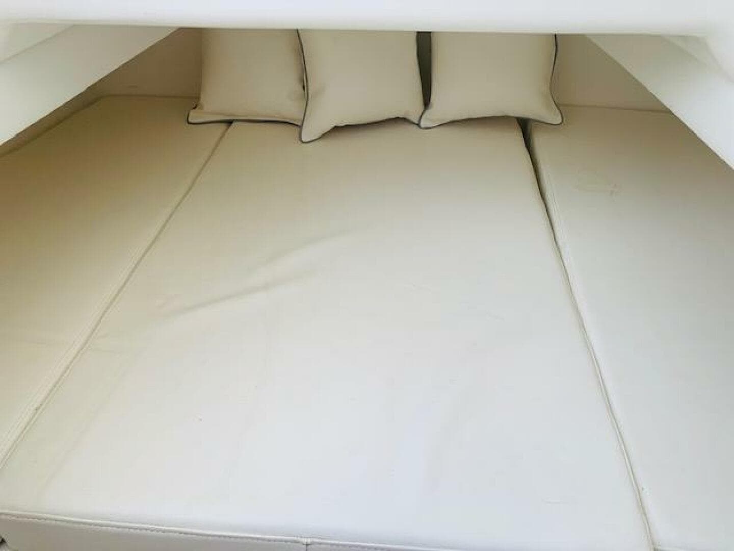 2020 SeaHunter 39 Tournament cabin interior with beige cushions and pillows.