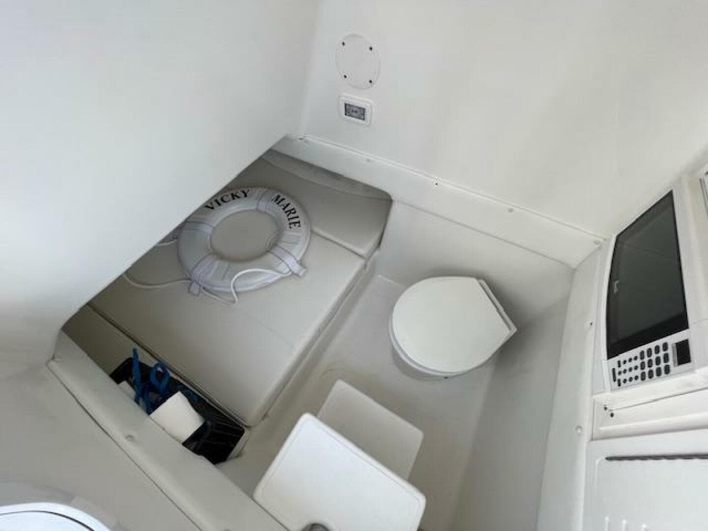 Interior of 2020 SeaHunter 39 Tournament boat with seating, toilet, and life preserver.