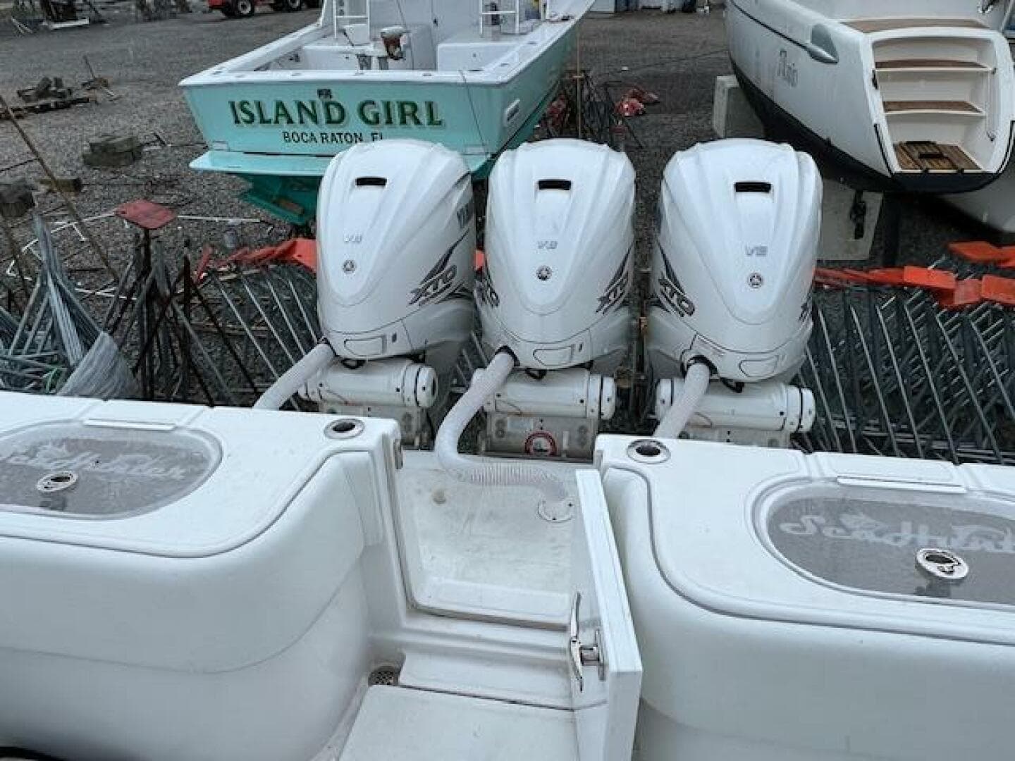 2020 SeaHunter 39 Tournament boat with triple outboard engines, docked near other vessels.