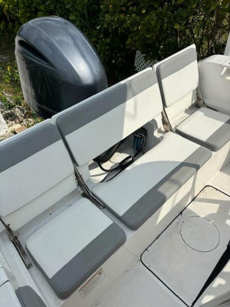 White and gray seating on a 2016 Release 208 RX boat with an outboard motor.