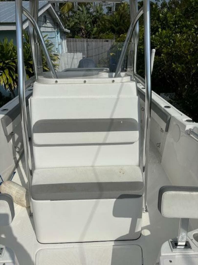 2016 Release 208 RX boat interior with seating and railing, surrounded by greenery.