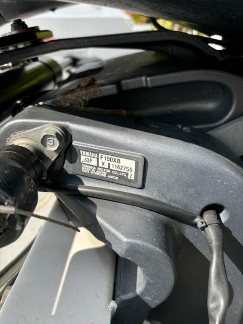 Close-up of Yamaha F150XB engine part with serial number, 2016 Release 208 RX model.