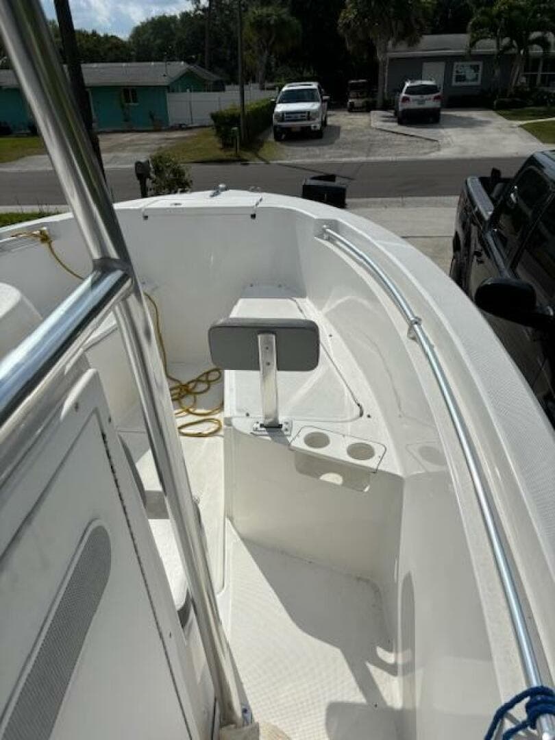 2016 Release 208 RX boat interior with seating and rod holders, parked in a residential area.