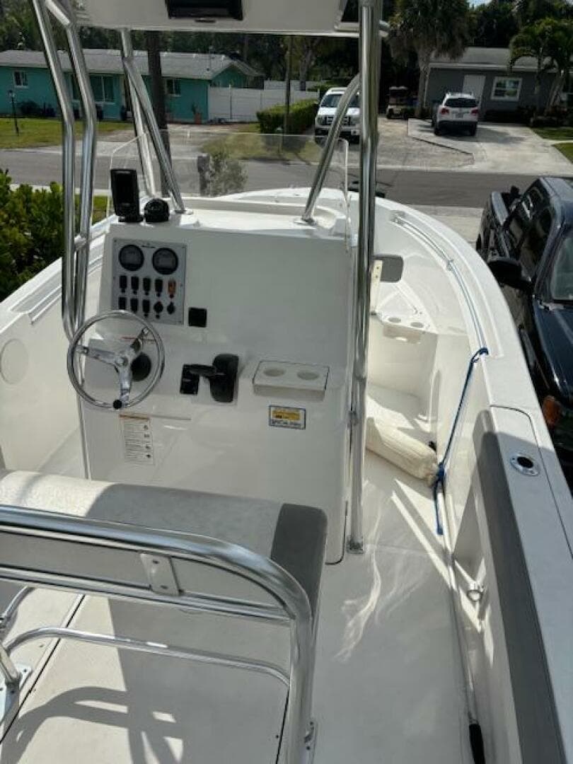 2016 Release 208 RX boat with console and seating, parked in a residential area.