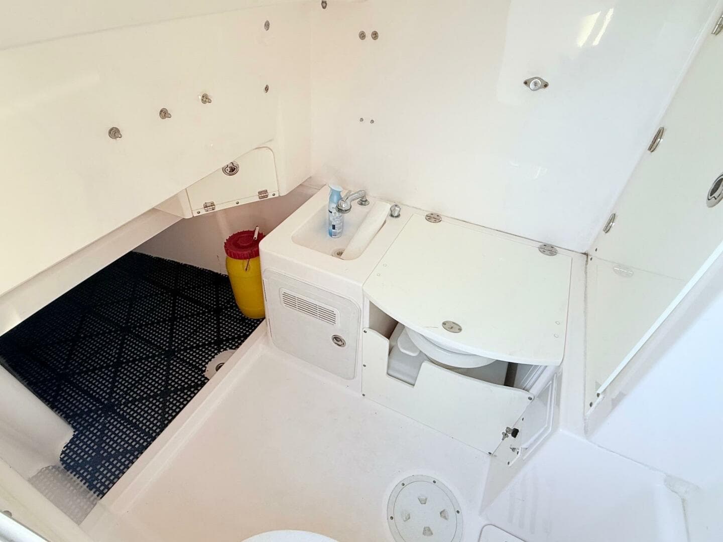 2014 Everglades 355 Center Console boat interior with compact bathroom amenities.