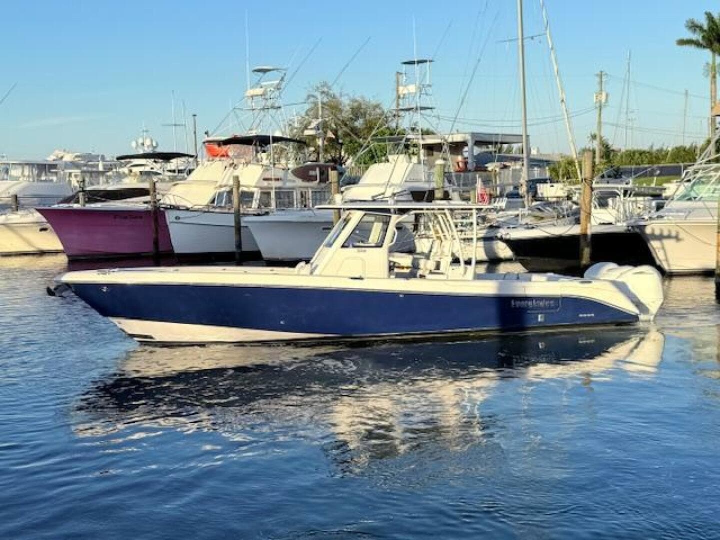 2014 Everglades 355 Center Console boat docked in a marina.
