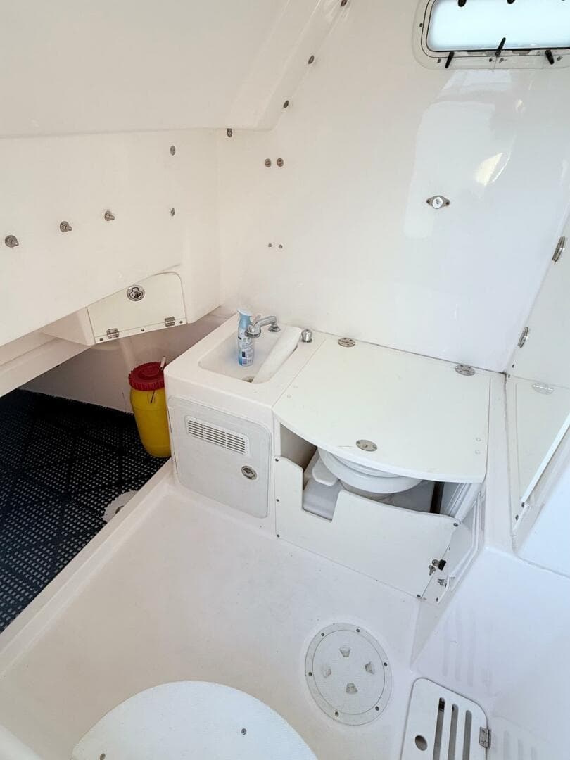 2014 Everglades 355 Center Console boat interior with sink and storage.