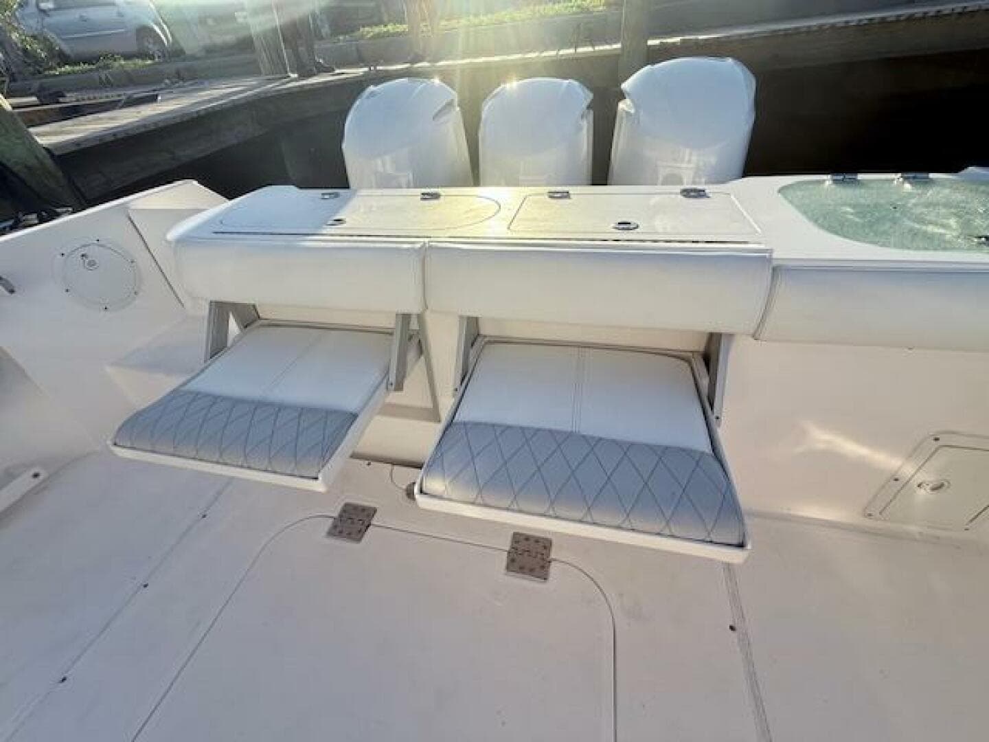 2014 Everglades 355 Center Console boat with foldable seats and triple engines.
