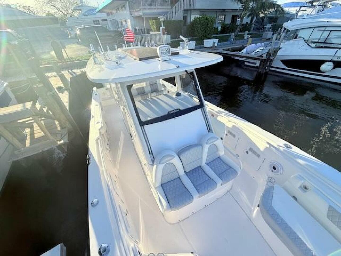 2014 Everglades 355 Center Console boat docked at marina, featuring spacious seating.