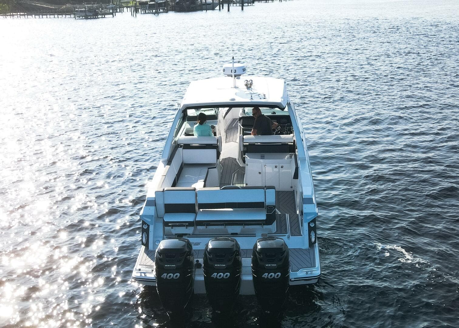 2023 Monterey 385 Super Sport boat cruising on open water, rear view.