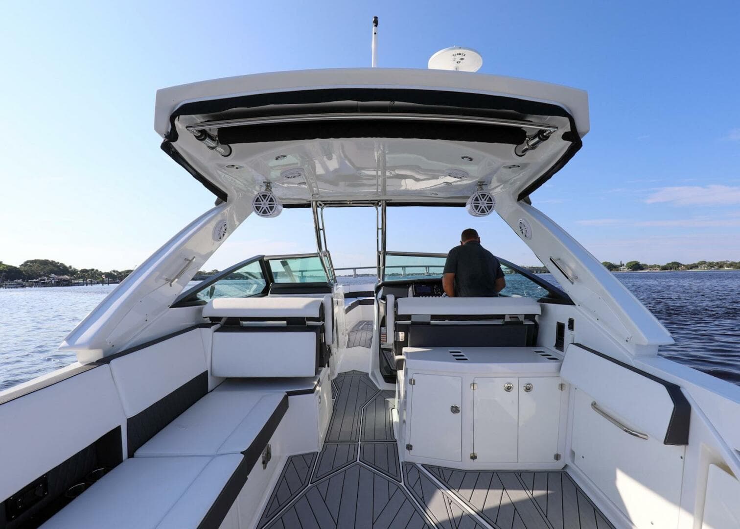 2023 Monterey 385 Super Sport boat interior with seating and helm, on a sunny day.