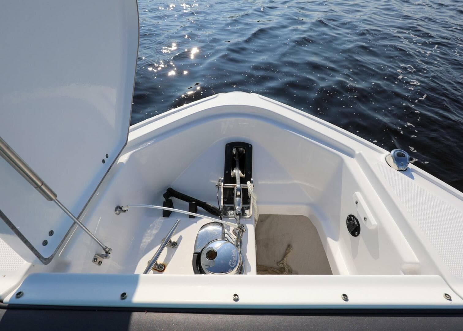 2023 Monterey 385 Super Sport boat anchor compartment with open hatch on calm water.
