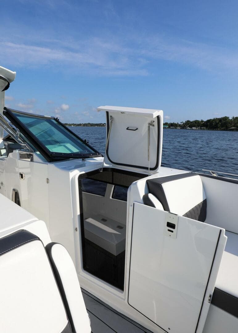 2023 Monterey 385 Super Sport boat interior with open door, on a sunny day by the water.