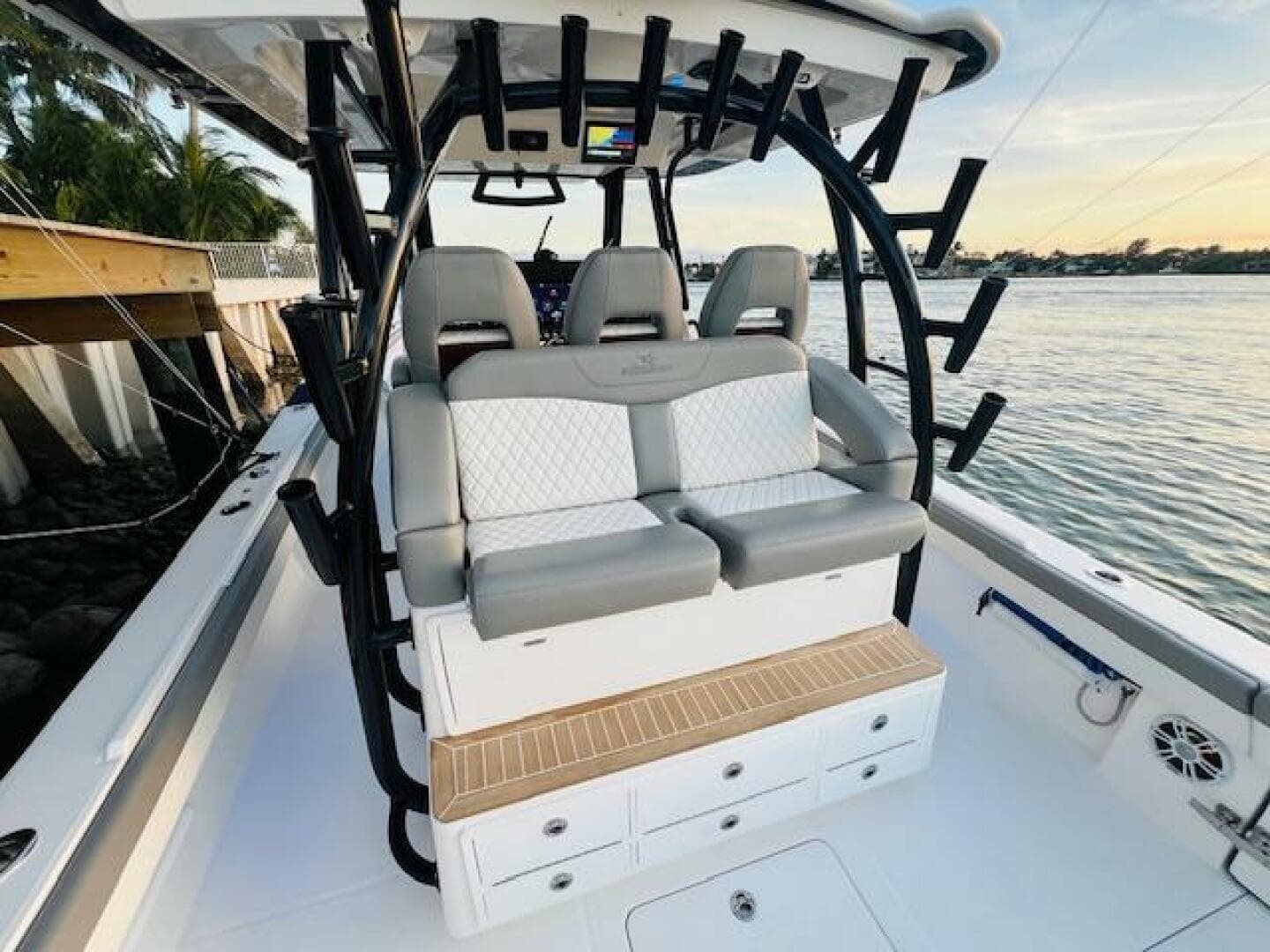 2024 Regulator 41 boat interior with cushioned seating and rod holders by the water.