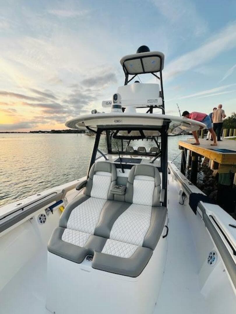 2024 Regulator 41 boat with luxurious seating, docked at sunset.