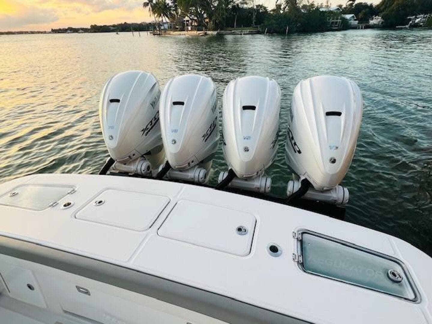 2024 Regulator 41 boat with four powerful outboard engines on a serene water backdrop.