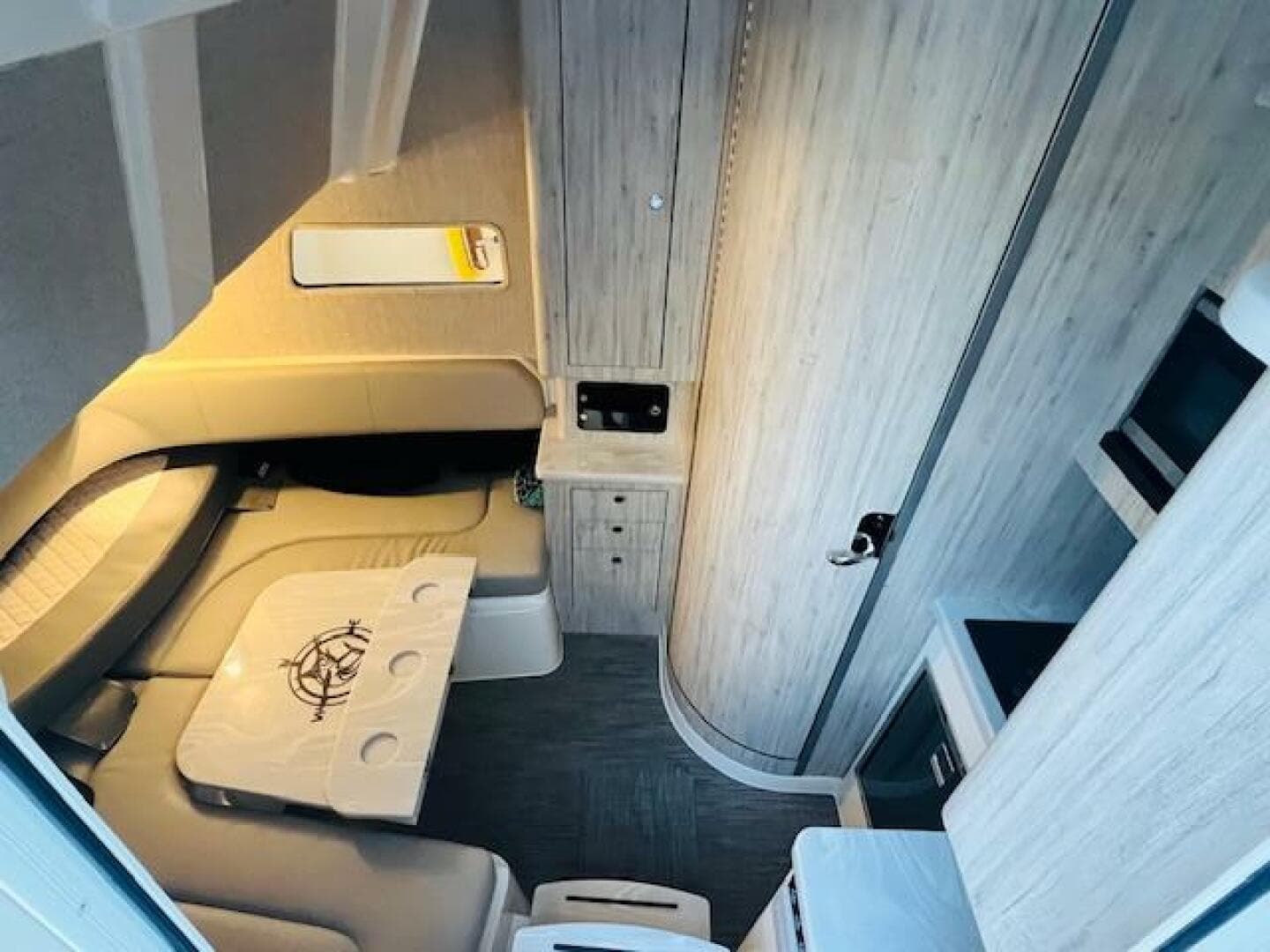 2024 Regulator 41 cabin interior with modern seating, table, and wood paneling.