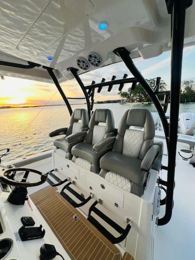 2024 Regulator 41 boat interior with luxury seating, overlooking a serene sunset on the water.