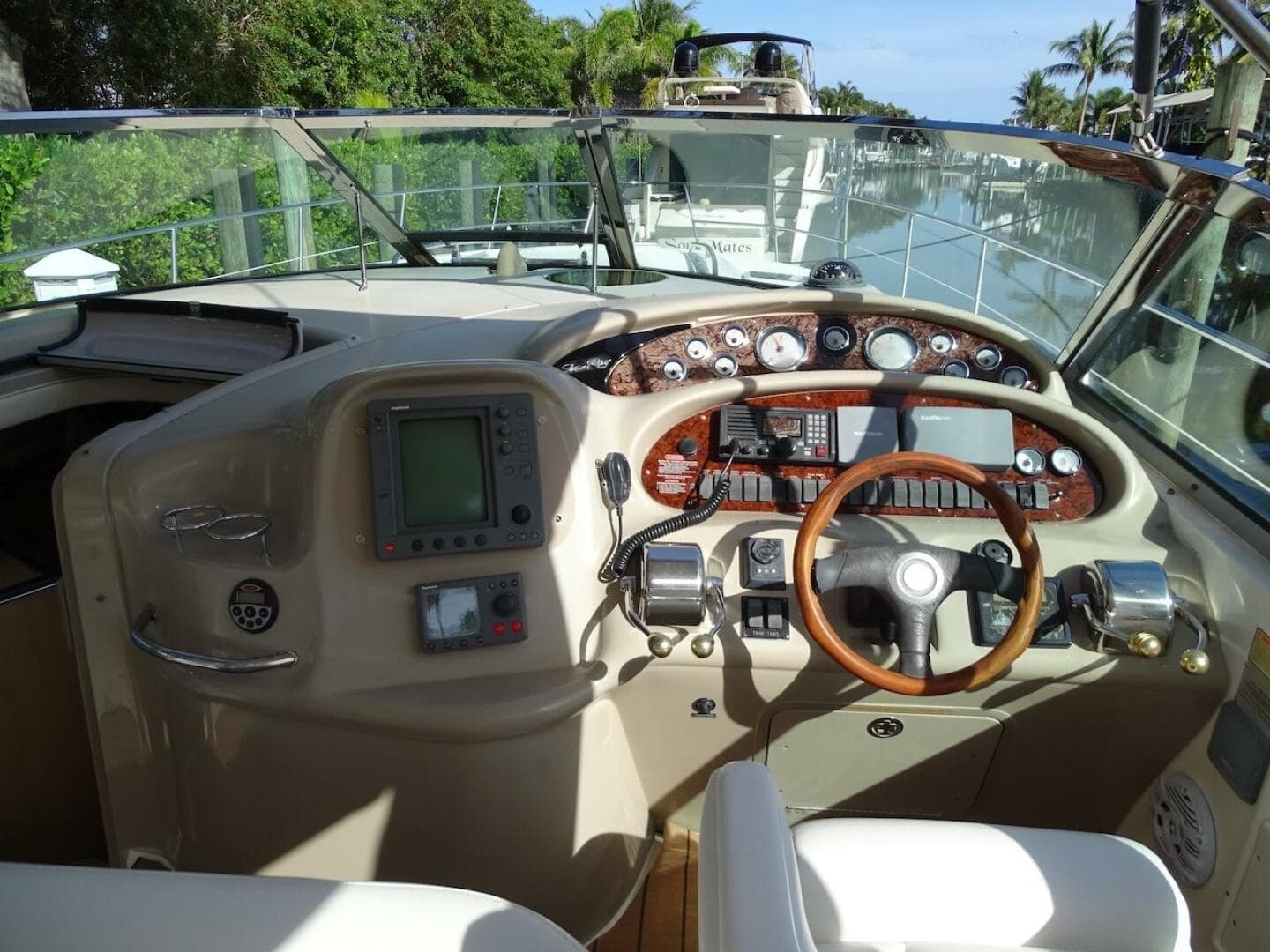 2001 Sea Ray 410 Sundancer helm with navigation instruments and wooden steering wheel.