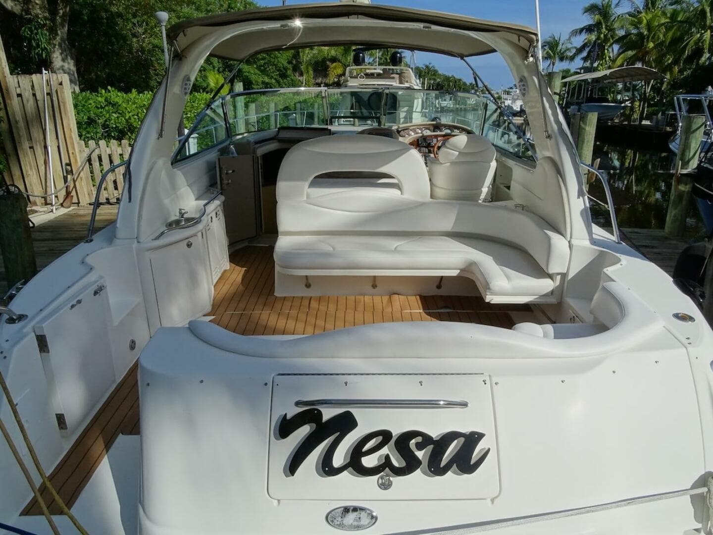 2001 Sea Ray 410 Sundancer yacht with white seating and wooden deck.