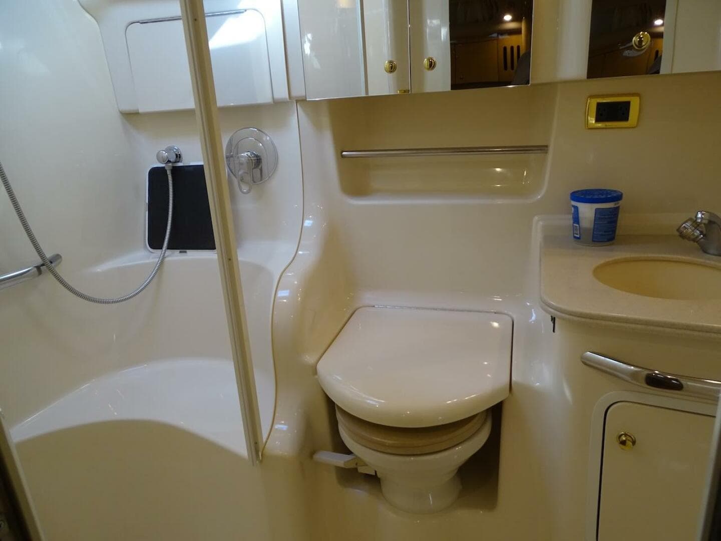Bathroom interior of 2001 Sea Ray 410 Sundancer yacht, featuring shower, toilet, and sink.