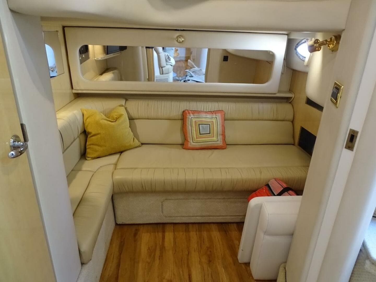 Interior of 2001 Sea Ray 410 Sundancer with beige seating and decorative pillows.