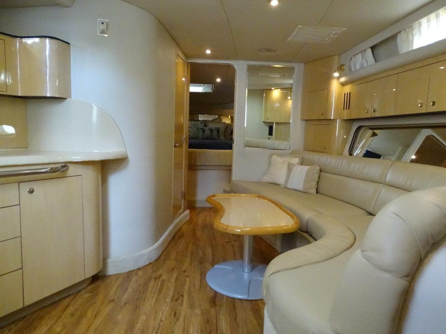 Luxurious interior of 2001 Sea Ray 410 Sundancer yacht with elegant seating and wood flooring.